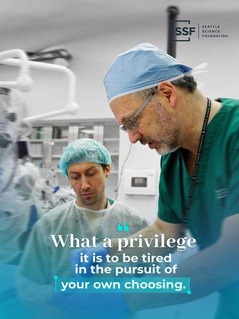 A surgeon guiding a trainee in the SSF lab, with the quote: What a privilege it is to be tired in the pursuit of your own choosing.